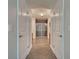 Bathroom hallway with double doors and tile flooring that leads to glass shower and cabinets at 14352 Pocono Ave, Port Charlotte, FL 33981
