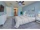 Digitally staged bedroom with an upholstered bed, dresser, nightstands, rug, and decorations at 14352 Pocono Ave, Port Charlotte, FL 33981