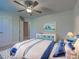 This bedroom features carpeting, ceiling fan, nautical decor and a crib at 14352 Pocono Ave, Port Charlotte, FL 33981