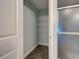 Linen closet with wire shelving and tile flooring next to the shower at 14352 Pocono Ave, Port Charlotte, FL 33981