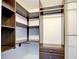 Walk-in closet with custom wood shelving and drawers and two closet rods at 14352 Pocono Ave, Port Charlotte, FL 33981