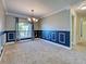 An open dining room with decorative molding, hardwood floors, and a view of the outdoors at 14352 Pocono Ave, Port Charlotte, FL 33981