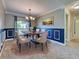 Dining room with decorative molding, hardwood floors, and a dining set for four people at 14352 Pocono Ave, Port Charlotte, FL 33981