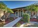 Close up of covered front porch featuring decorative columns, walkway and lush landscaping at 14352 Pocono Ave, Port Charlotte, FL 33981