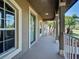 Welcoming covered front porch with decorative columns and railing, a relaxing spot at 14352 Pocono Ave, Port Charlotte, FL 33981