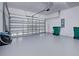 Spacious two car garage featuring sealed concrete flooring, automatic garage door and additional storage space at 14352 Pocono Ave, Port Charlotte, FL 33981