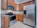 Beautiful kitchen with stainless appliances including oven, microwave and refrigerator and matching cabinets at 14352 Pocono Ave, Port Charlotte, FL 33981