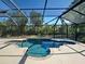 Screened in backyard pool with a concrete deck and a spa at 14352 Pocono Ave, Port Charlotte, FL 33981
