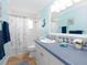 Charming bathroom with a vanity, shower with seashell-themed curtain, and nautical accents at 1440 Overbrook Rd, Englewood, FL 34223