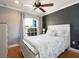 Inviting bedroom with hardwood floors, a ceiling fan, and neutral colored walls at 1440 Overbrook Rd, Englewood, FL 34223