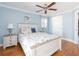 Charming bedroom with a decorative turtle wall art, complemented by beach-themed bedding and furnishings at 1440 Overbrook Rd, Englewood, FL 34223
