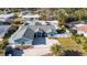 Exterior of a home with light-blue paint, a gray roof, an enclosed backyard, and green landscaping at 1440 Overbrook Rd, Englewood, FL 34223