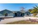 The exterior showcases a charming façade, two-car garage, and beautiful landscaping at 1440 Overbrook Rd, Englewood, FL 34223