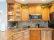 Kitchen with stainless steel appliances, granite countertops, custom cabinets and mosaic backsplash at 1440 Overbrook Rd, Englewood, FL 34223