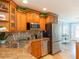 Kitchen with stainless steel appliances, granite countertops, and beautiful custom wood cabinetry at 1440 Overbrook Rd, Englewood, FL 34223