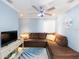 Cozy living room with a comfortable sectional sofa, ceiling fan, and modern decor at 1440 Overbrook Rd, Englewood, FL 34223