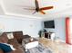 Inviting living room features a plush brown sectional sofa and a decorative ceiling fan at 1440 Overbrook Rd, Englewood, FL 34223
