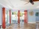 Open living area with tile floors and sliding glass doors provides a view of the backyard pool at 1440 Overbrook Rd, Englewood, FL 34223