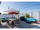 Inviting patio featuring comfortable seating, dining area, and umbrellas for shade, ideal for outdoor living at 1440 Overbrook Rd, Englewood, FL 34223