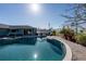 In-ground swimming pool with tiled trim, surrounded by patio, and outdoor seating near the home at 1440 Overbrook Rd, Englewood, FL 34223