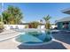 Landscaped in-ground pool and spa offering a serene backyard retreat with lush landscaping at 1440 Overbrook Rd, Englewood, FL 34223