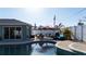 Outdoor swimming pool with seating, umbrellas, and tiled patio, surrounded by a privacy fence at 1440 Overbrook Rd, Englewood, FL 34223