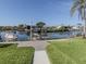 Serene waterfront backyard featuring lush greenery and a private dock on the canal, perfect for boat lovers at 1503 Marlin St, Nokomis, FL 34275