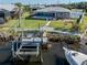 Backyard features a boat dock, screened-in pool, grassy area, and waterfront views at 1503 Marlin St, Nokomis, FL 34275