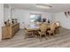 Formal dining room with wood floors, buffet, light fixture and seating for six at 1503 Marlin St, Nokomis, FL 34275