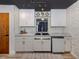 Updated kitchen features marble countertops, stylish tile backsplash, and modern fixtures at 1503 Marlin St, Nokomis, FL 34275