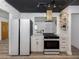 Modern kitchen with white cabinets, a glass hood, and stainless steel appliances at 1503 Marlin St, Nokomis, FL 34275