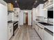 Beautiful modern kitchen with sleek white cabinetry, stainless steel appliances, and stylish hardware at 1503 Marlin St, Nokomis, FL 34275
