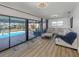 Spacious living room featuring an oversized sectional with a view of the pool and backyard at 1503 Marlin St, Nokomis, FL 34275
