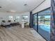 Open-concept room with seating, desk, and access to a pool offering seamless indoor-outdoor living at 1503 Marlin St, Nokomis, FL 34275