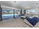 Cozy living room with sliding glass doors leading to a screened lanai and a beautiful pool area at 1503 Marlin St, Nokomis, FL 34275