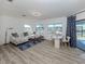 Sunlit living space with large windows, comfortable seating, and a view of the pool area at 1503 Marlin St, Nokomis, FL 34275