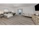 Light and airy main bedroom featuring wood floors, neutral paint and a sitting area with sliding glass doors at 1503 Marlin St, Nokomis, FL 34275