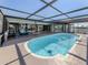 Inviting pool area surrounded by a screened-in enclosure, providing a private oasis for relaxation and enjoyment at 1503 Marlin St, Nokomis, FL 34275