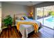 Bright bedroom featuring a queen size bed with direct access to the screened-in pool at 1611 Valley Dr, Venice, FL 34292