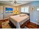 Comfortable bedroom with a ceiling fan, large window, and neutral decor at 1611 Valley Dr, Venice, FL 34292