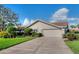 Spacious home featuring a two-car garage, concrete driveway and well manicured landscaping at 1611 Valley Dr, Venice, FL 34292