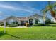 Charming single-story home with lush lawn, mature landscaping, and a welcoming front entrance at 1611 Valley Dr, Venice, FL 34292
