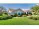 Beautiful front yard featuring a well-manicured lawn and professionally landscaped bushes and shrubbery at 1611 Valley Dr, Venice, FL 34292