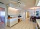 Bright kitchen with white cabinets, connecting to the dining area, and plenty of counter space at 1611 Valley Dr, Venice, FL 34292