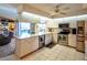 Bright kitchen with stainless steel appliances and white cabinetry, connecting to the outdoor pool area at 1611 Valley Dr, Venice, FL 34292