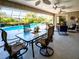 Relaxing screened lanai with a dining table and seating area overlooking the pool at 1611 Valley Dr, Venice, FL 34292