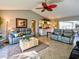 Cozy living room with comfortable seating, tiled floors, and sliding doors to the screened-in lanai at 1611 Valley Dr, Venice, FL 34292