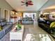 Spacious living room featuring tile flooring, vaulted ceiling, and modern furnishings at 1611 Valley Dr, Venice, FL 34292