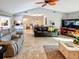 Open living room with tile floors, vaulted ceiling, seamlessly connecting to the dining area at 1611 Valley Dr, Venice, FL 34292