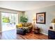 Comfortable sitting area boasts pool views, a botanical sofa, and a decorative tropical artwork at 1611 Valley Dr, Venice, FL 34292
